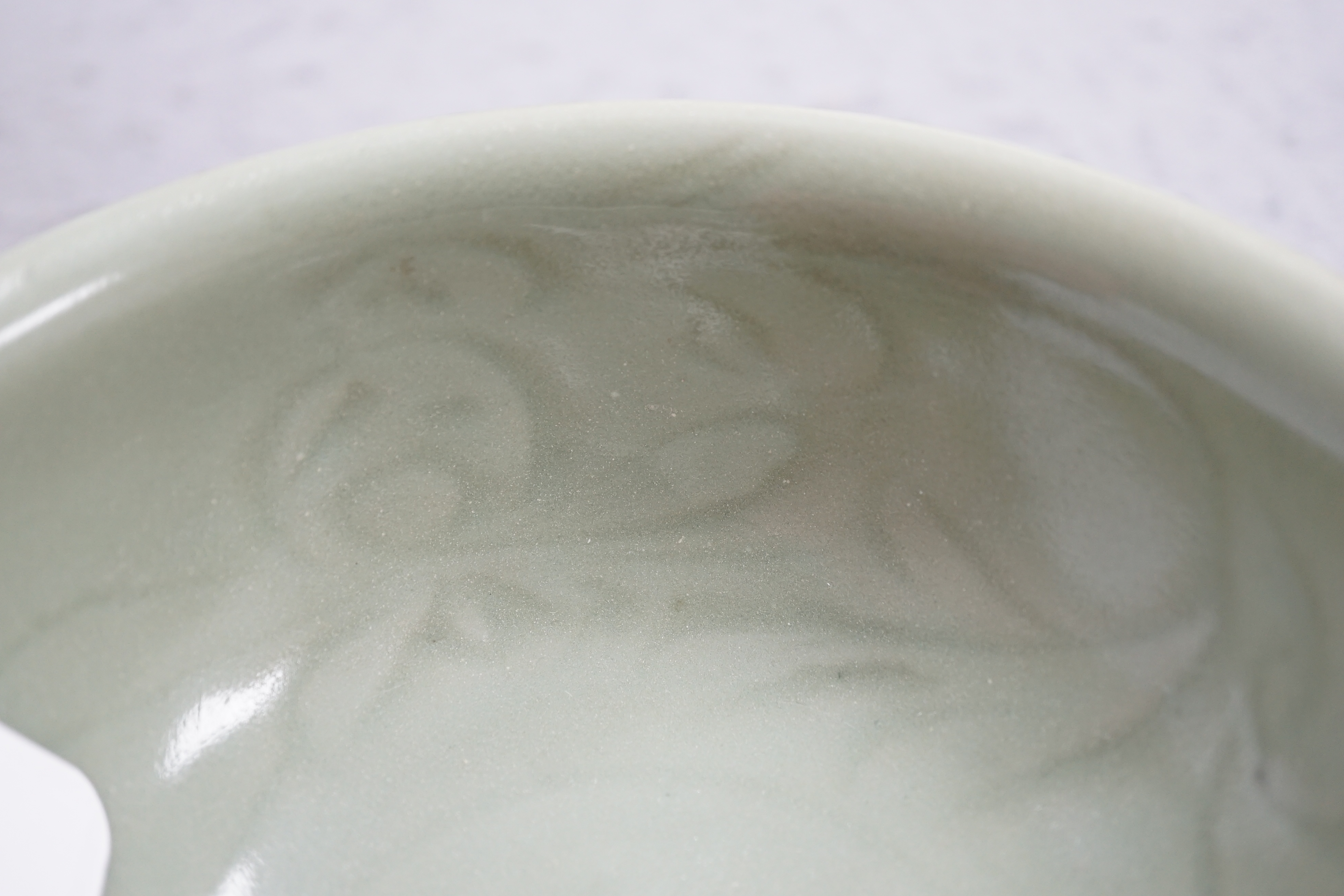 A Chinese Longquan celadon bowl, the interior carved with lotus flowers and the exterior with foliate lappets, 15.2cm diameter., Provenance - Robert Ricketts collection, formerly sold by Robert McPherson, London and S. M